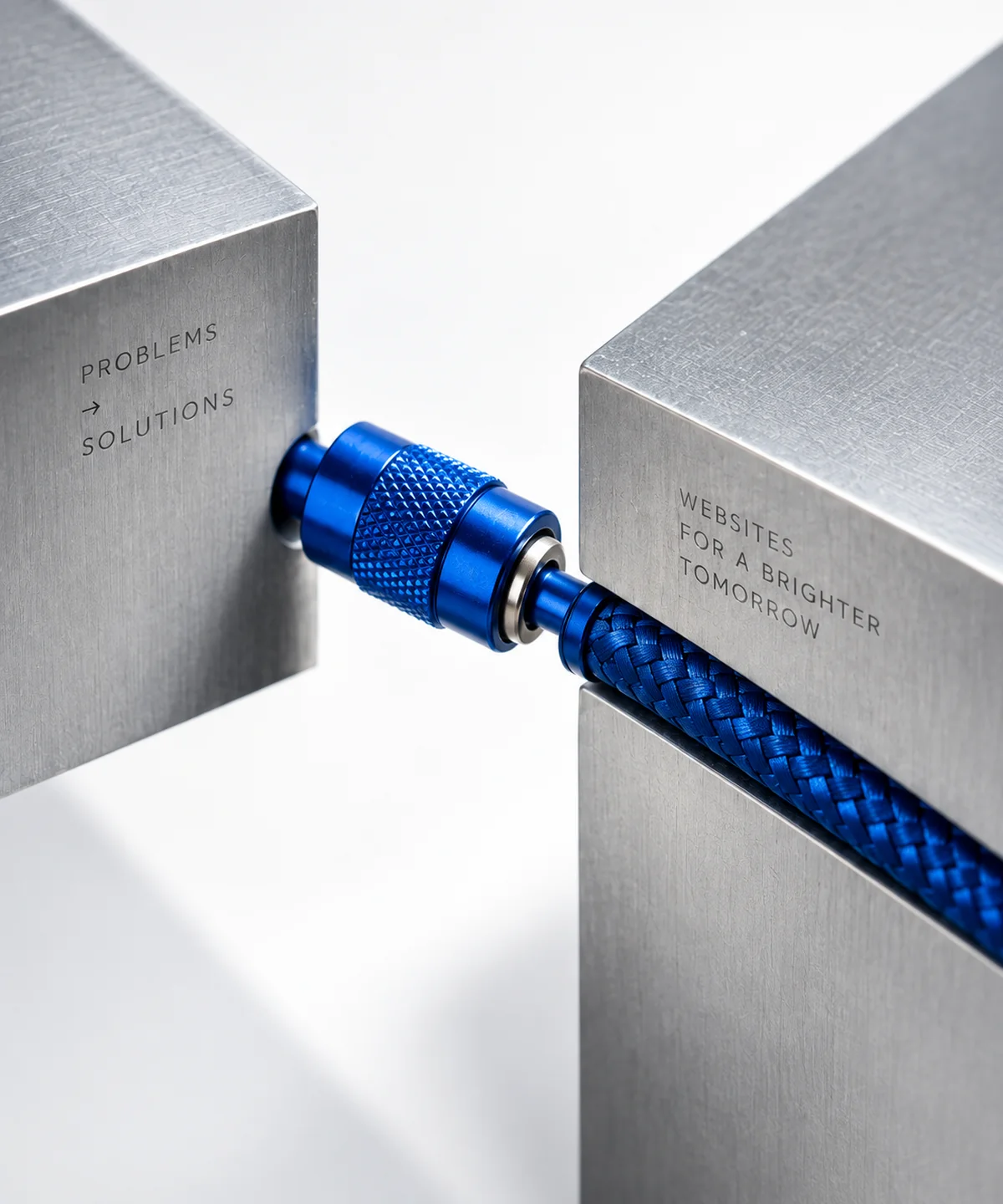 A cobalt connector joining two brushed steel blocks, representing a website moving from problems to solutions.